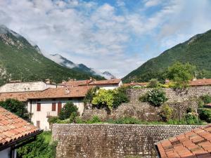 a village in the mountains with a stone wall at Affittacamere Casa Bliss in Venzone