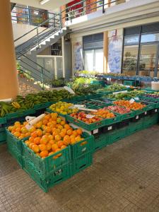 a display of oranges and other fruits in a store at Farinha's Apartment in Ribeira Brava