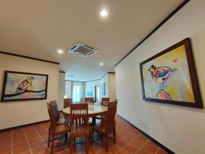 a dining room with a table and chairs at Riviera Suites Melaka in Melaka