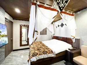 Ένα ή περισσότερα κρεβάτια σε δωμάτιο στο Hotel BaliBali 鶯谷