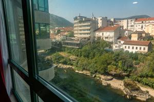 a view of a river from a window at River Harmony Apartment in Mostar
