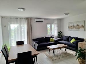 a living room with a couch and a table at Apartment Tanya with jacuzzi in Rijeka