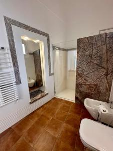a bathroom with a sink and a mirror and a shower at Casa Leoci in Lecce +10 photos