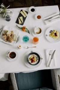 a white table with plates of food on it at Parkhotel Laurin in Bolzano