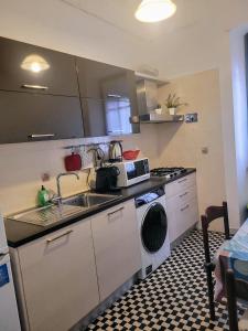 a kitchen with a sink and a washing machine at Sweet Holiday in Rome