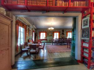 a dining room with tables and chairs in a building at Cirkus Hostel Holken in Inkoo
