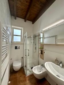 a bathroom with a sink and a toilet and a shower at Casa Leoci in Lecce