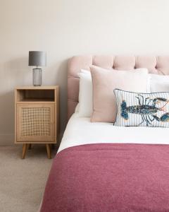 a bedroom with a large bed with a purple blanket at Luxury Family Home in Central Windsor with Large Garden, Games Room, Office, Parking & Pet-Friendly in Windsor
