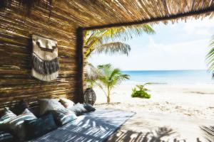 a room with a bed on the beach at Nomade Tulum in Tulum
