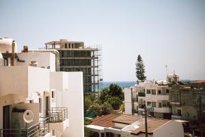 a view of a city with white buildings at Sunrise Beach Apartments in Larnaka