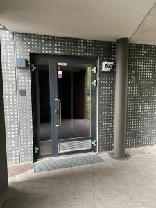 a glass door on the side of a building at Helsinki Airport Apartment Stay in Vantaa