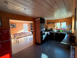 a kitchen with a stove and a couch in a room at Le panoramique in Campan