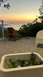 a tray of bottles of beer sitting on a beach at La Valle di Hermes in Piraino +5 photos