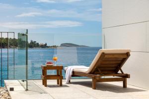 ein Stuhl auf einer Terrasse mit Blick auf das Meer in der Unterkunft Hotel Vallum by St Pietro in Cavtat