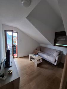 a living room with a couch and a table at Chalet LENA & One Bedroom Apartment Lena in Žabljak