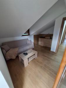 a living room with a couch and a table at Chalet LENA & One Bedroom Apartment Lena in Žabljak +16 photos