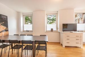 a dining room with a table and chairs at Wohnung für 8 Personen in ehemaligem Weingut mit 4 Schlafzimmern in Rommersheim
