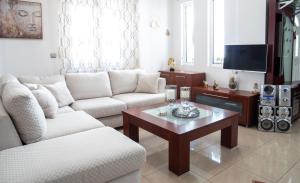 a living room with two couches and a coffee table at Rena's House in Ierapetra