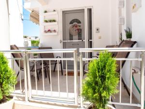 a balcony with chairs and a table in a house at Rena's House in Ierapetra