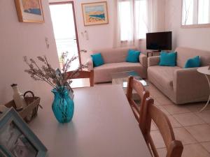 a living room with a vase on a table at Amalia House Kalamaki in Kalamaki Heraklion