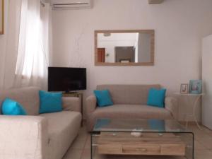 a living room with a couch and a mirror at Amalia House Kalamaki in Kalamaki Heraklion +37 photos