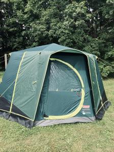 a green tent sitting on top of a field at Stand-up tent and Sauna, farm experience BB in Atsalama +7 photos