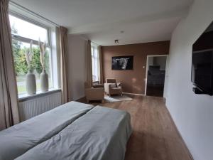 a bedroom with a bed and a large window at Vakantieverblijf in Wijnbergen in Wijnbergen