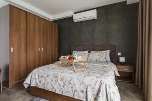 a bedroom with a bed with a tray on it at DuplexPenthouse seafront with hot tub by Homely in St. Paul's Bay