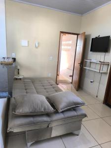 a room with a bed with pillows on it at Apartamento completo in Montes Claros