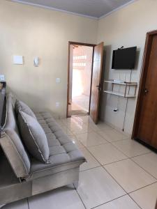 a living room with a couch and a flat screen tv at Apartamento completo in Montes Claros
