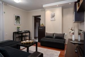 a living room with a couch and a table at Apartman Neli in Delnice