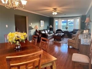 a living room with a table with flowers on it at Lancaster Inn B&B in Bonavista