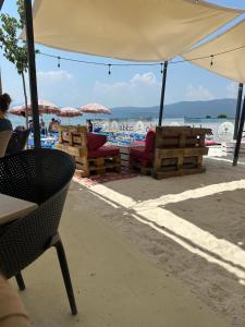 a beach with chairs and umbrellas on the beach at D&M Apartments in Struga