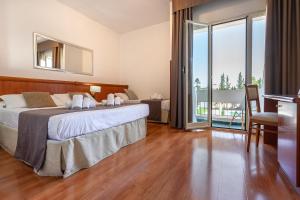 Postel nebo postele na pokoji v ubytování Garden Hotel