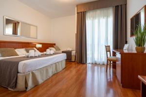 Postel nebo postele na pokoji v ubytování Garden Hotel