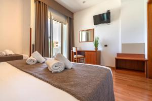 Postel nebo postele na pokoji v ubytování Garden Hotel