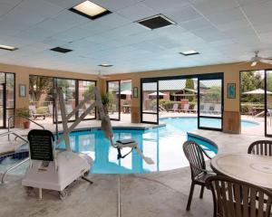 a swimming pool with a slide in the middle at Comfort Suites Parkersburg South in Mineralwells