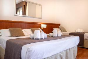 Postel nebo postele na pokoji v ubytování Garden Hotel