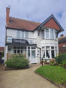 a white house with a sign that reads sunscribe at The Sandgate in Skegness