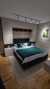 a large bedroom with a large bed with green sheets at Apartman Đorđe in Vrnjačka Banja