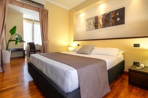 Postel nebo postele na pokoji v ubytování Garden Hotel