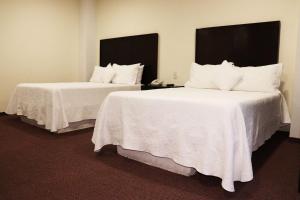 Voodi või voodid majutusasutuse Wyndham Garden Aguascalientes Hotel & Casino toas