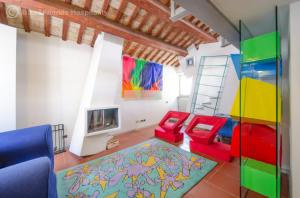 a living room with colorful furniture and a ladder at Casa Alceo in Pesaro