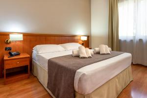 Postel nebo postele na pokoji v ubytování Garden Hotel