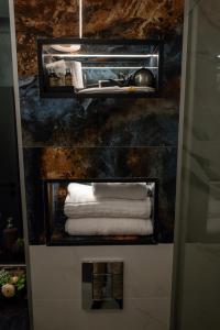 a bunch of towels on a shelf in a bathroom at AMAZE Costinesti in Costinesti +74 photos