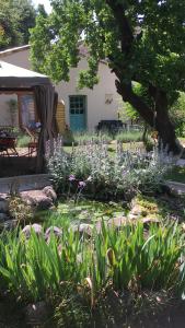 a garden with purple flowers in front of a house at Garden Annexe 2 in Villeneuve-Loubet