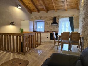 a kitchen and living room with a table and chairs at Apartments Rose 5 in Cres