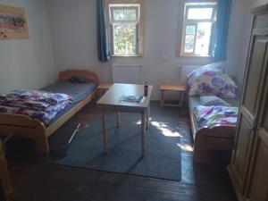 a room with two beds and a table in it at Castillo 1 in Ensheim