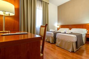 Postel nebo postele na pokoji v ubytování Garden Hotel