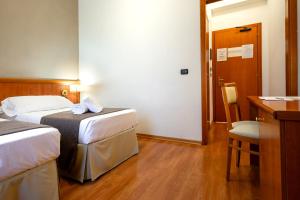 Postel nebo postele na pokoji v ubytování Garden Hotel